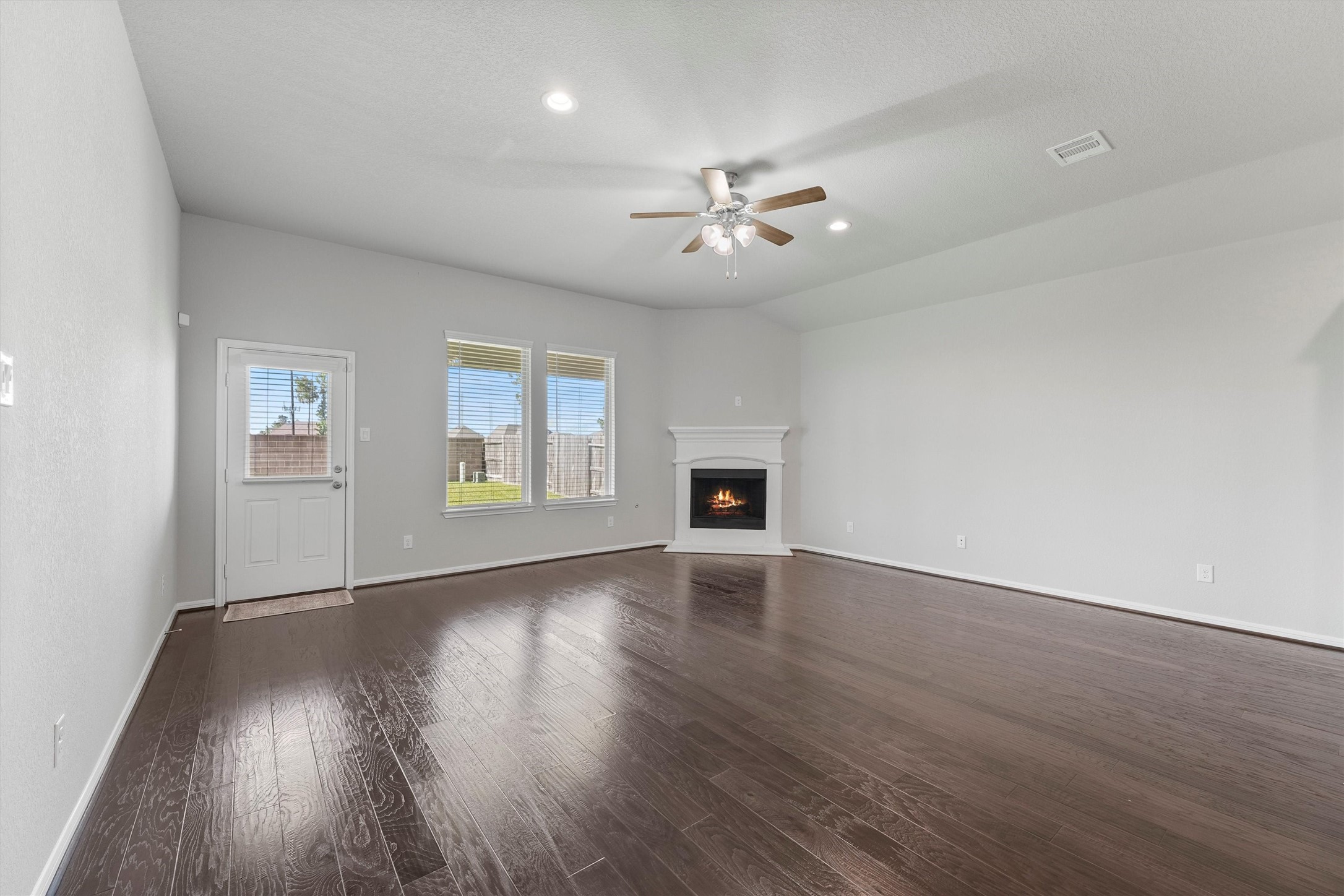 12043 Talmadge Reach Drive Humble, TX 77346 - Photo 13 of 33 a view of an empty room with a window and wooden floor