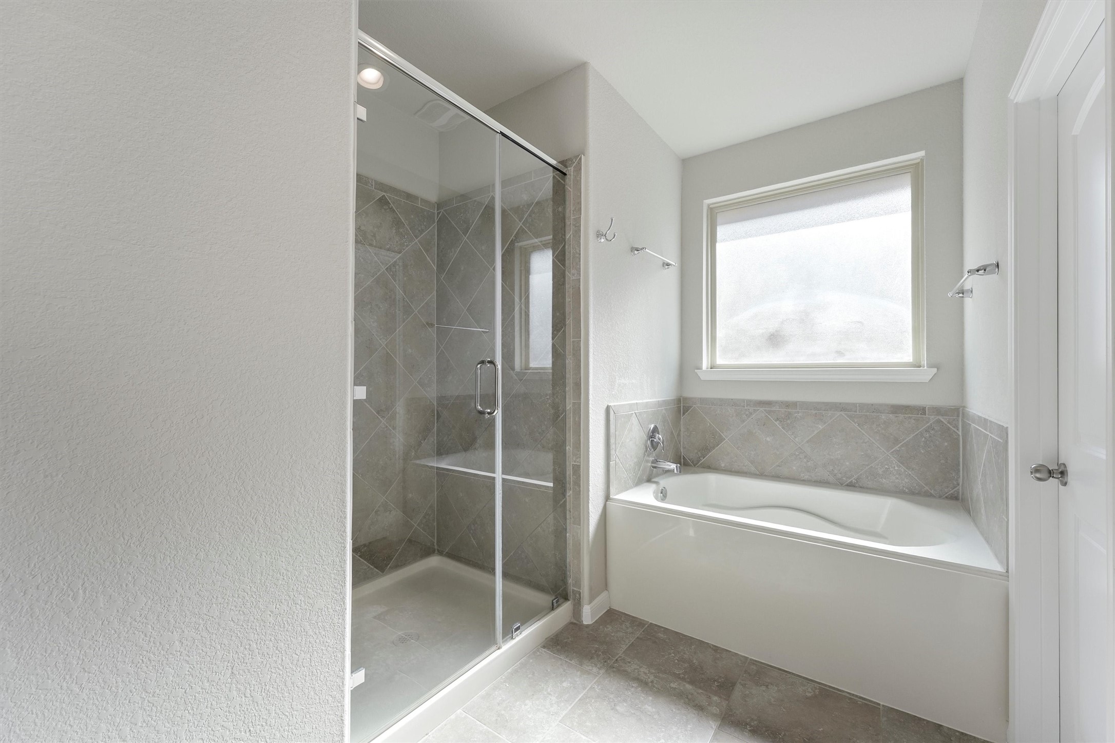 12043 Talmadge Reach Drive Humble, TX 77346 - Photo 17 of 33 a bathroom with a bathtub and a shower