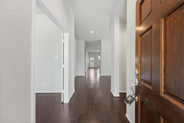 a view of a hallway with wooden floor