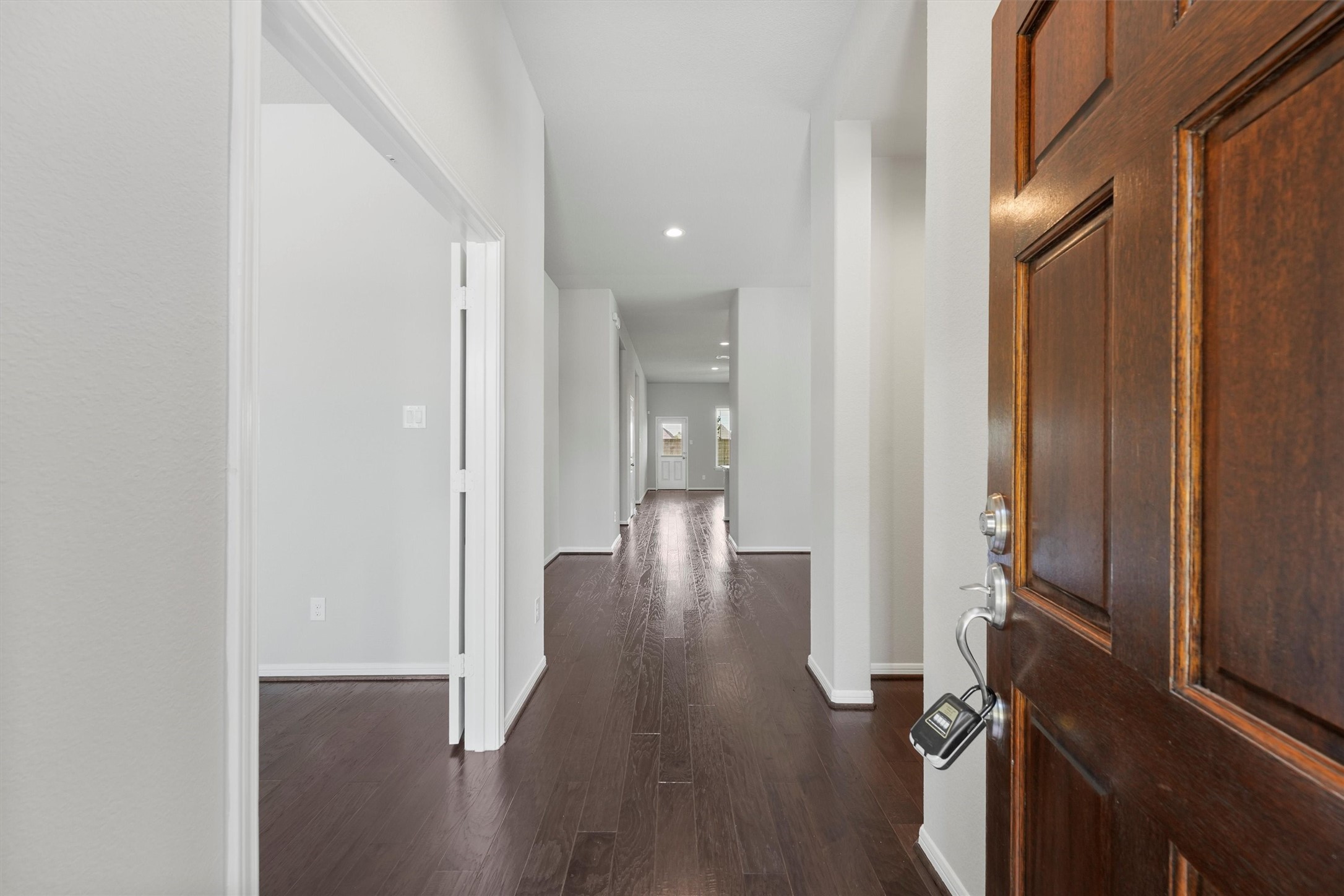 12043 Talmadge Reach Drive Humble, TX 77346 - Photo 3 of 33 a view of a hallway with wooden floor
