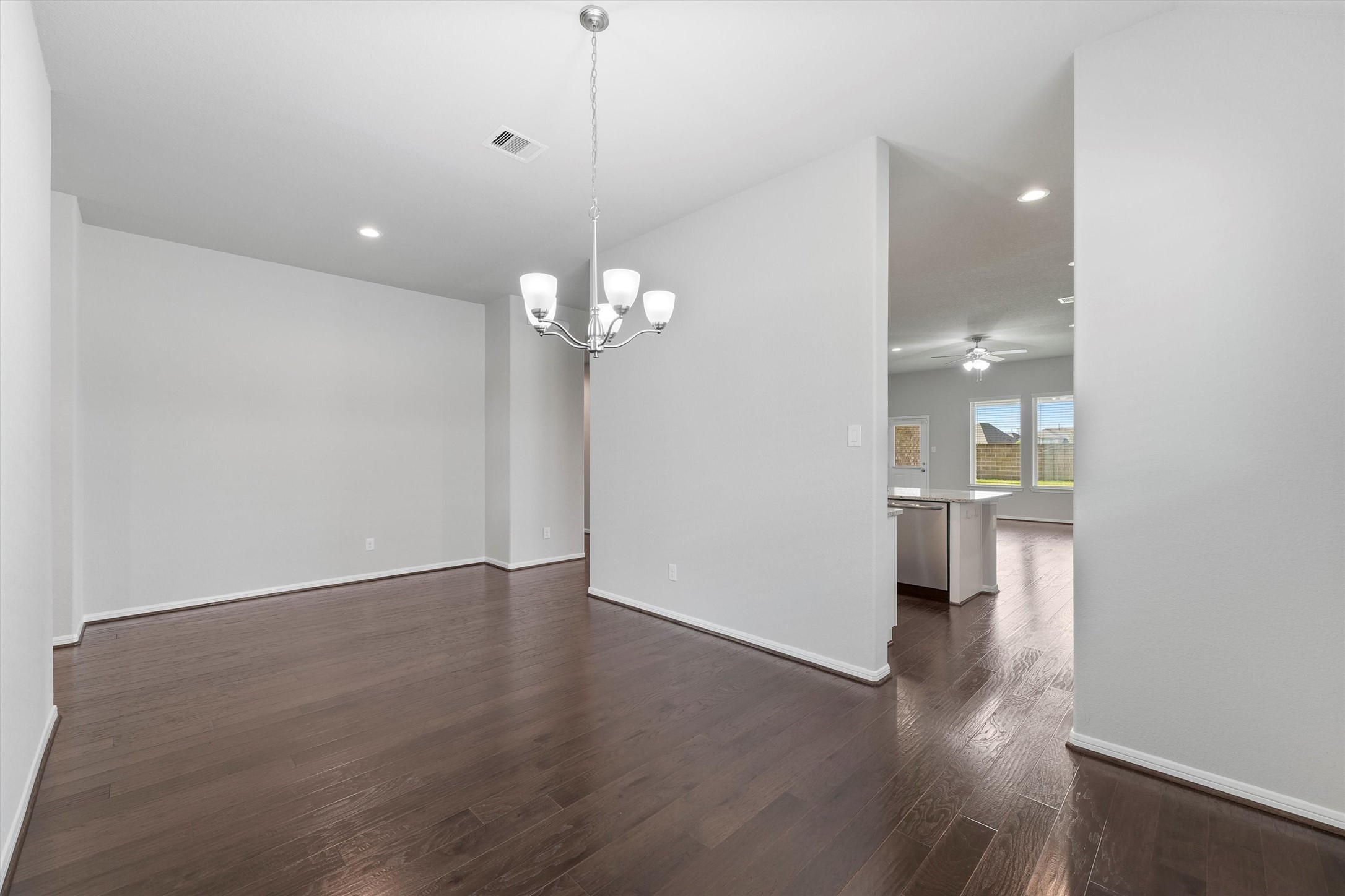 12043 Talmadge Reach Drive Humble, TX 77346 - Photo 8 of 33 a view of a room with wooden floor and kitchen view