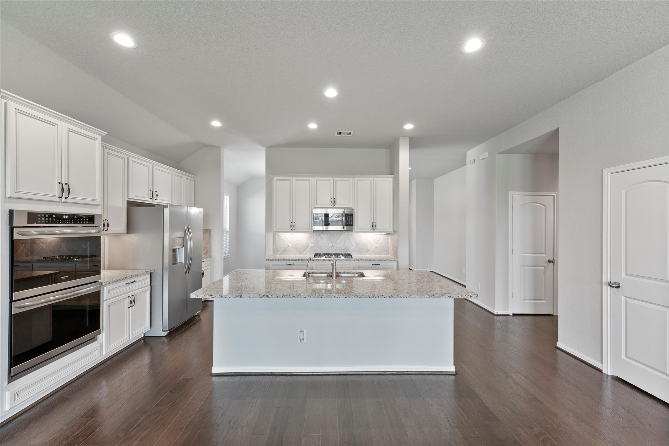 12043 Talmadge Reach Drive Humble, TX 77346 - Photo 9 of 33 a view of kitchen with stainless steel appliances refrigerator stove microwave and cabinets