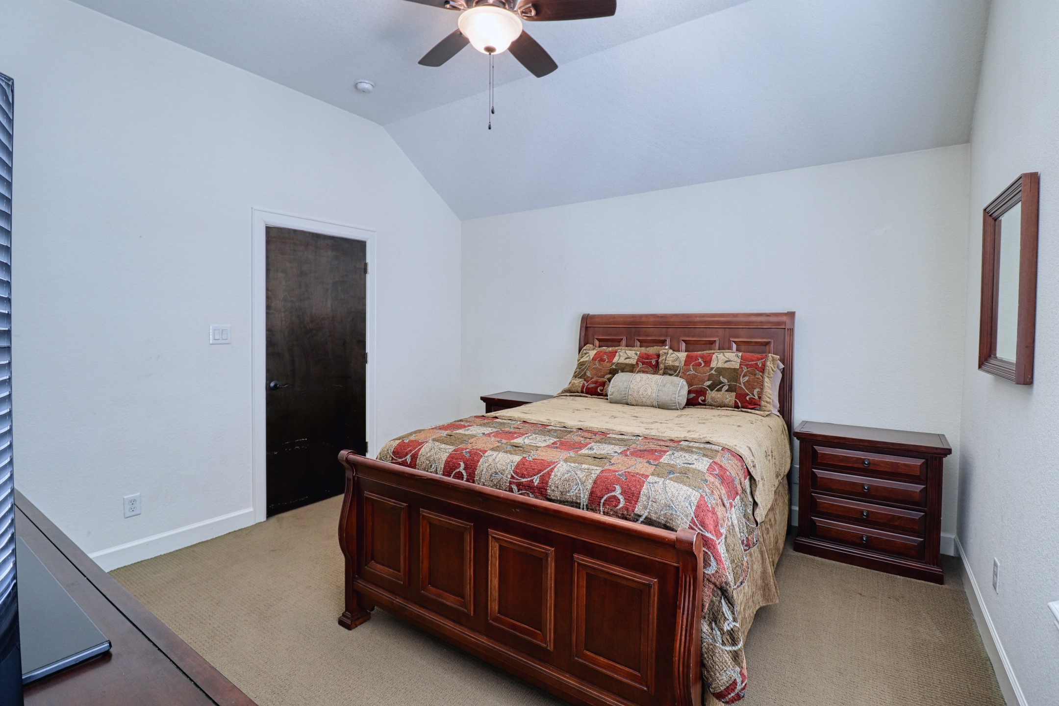 904 Patterson Street Houston, TX 77007 - Photo 28 of 30 a bedroom with a bed and a chandelier
