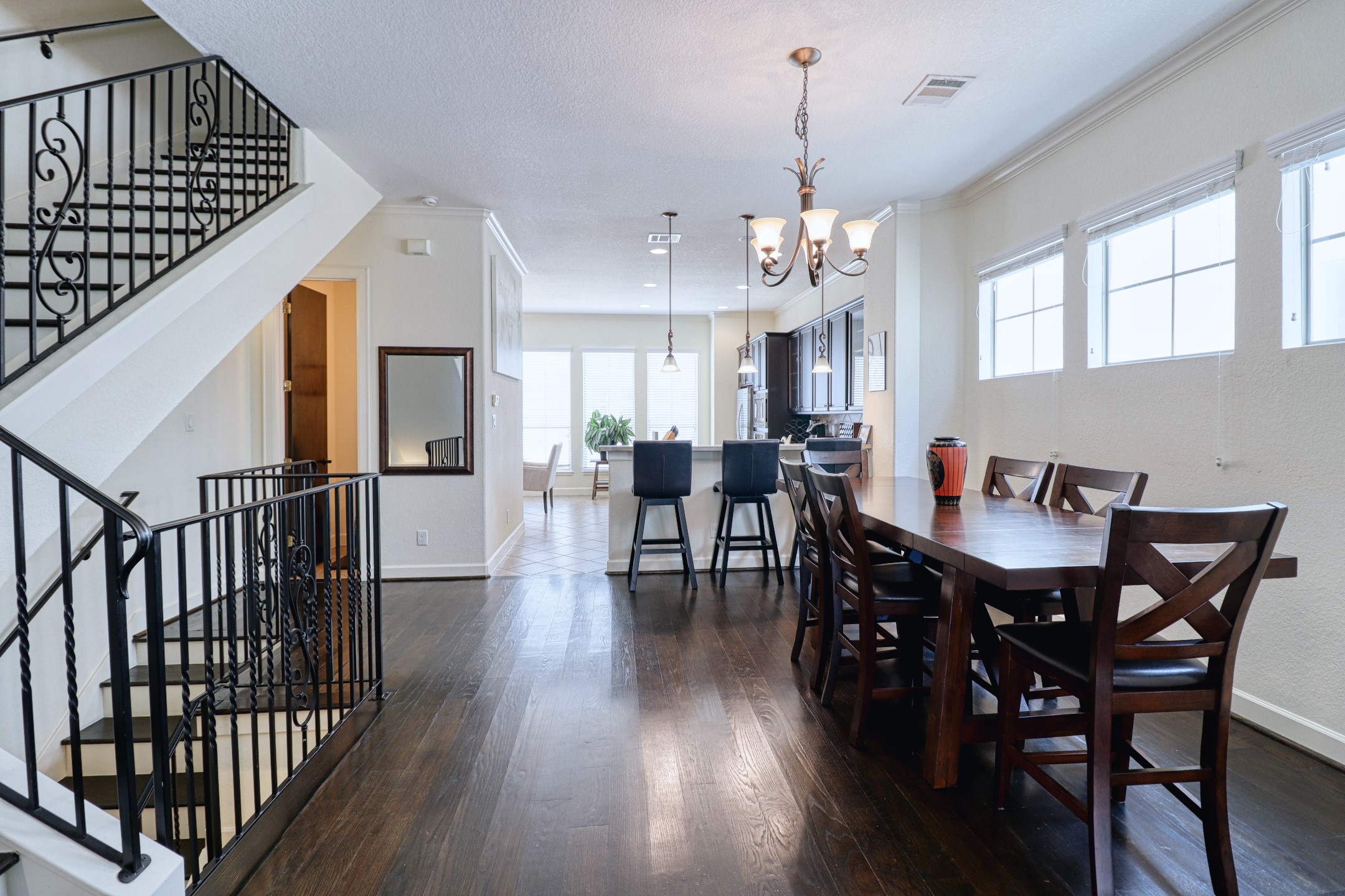 904 Patterson Street Houston, TX 77007 - Photo 7 of 30 a view of a dining room and livingroom with furniture wooden floor a chandelier