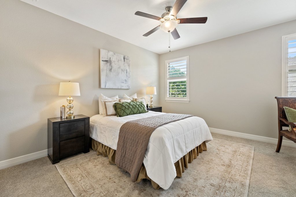 108 Berry Cove Georgetown, TX 78628 - Photo 25 of 39 a bedroom with a bed and a chandelier