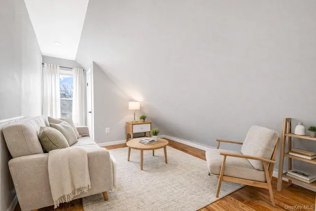 a living room with furniture and a lamp