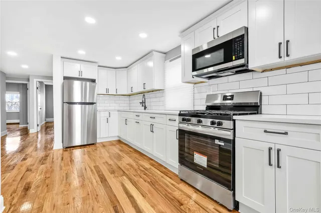 a kitchen with a sink stainless steel appliances and cabinets