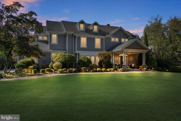 a front view of a house with swimming pool having outdoor seating