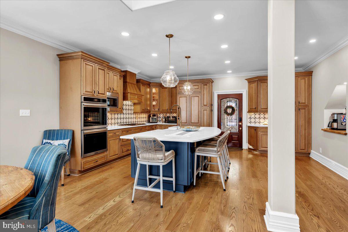 341 Station Avenue Haddonfield, NJ 08033 - Photo 21 of 71 a kitchen with stainless steel appliances kitchen island granite countertop a table chairs and a refrigerator