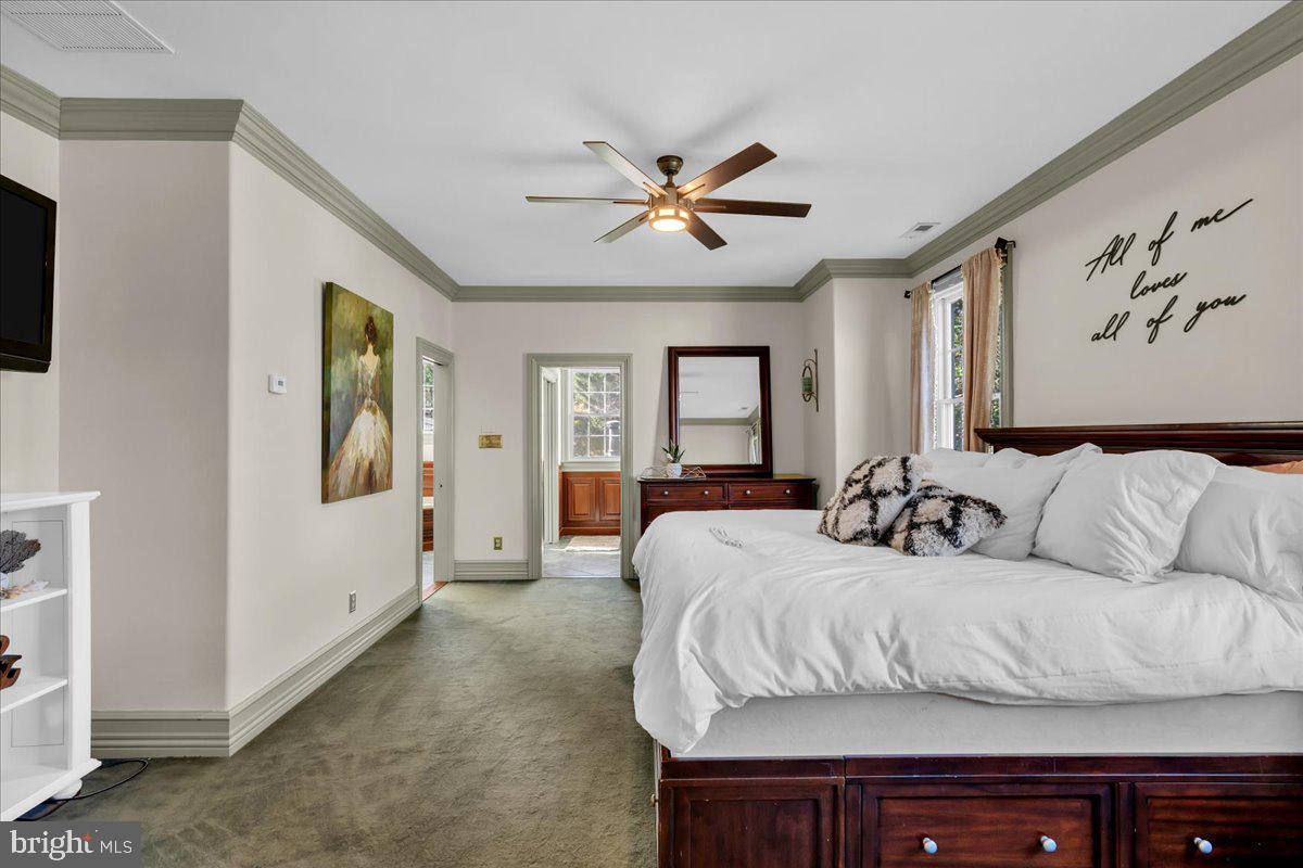 341 Station Avenue Haddonfield, NJ 08033 - Photo 32 of 71 a bedroom with a large bed and a chandelier
