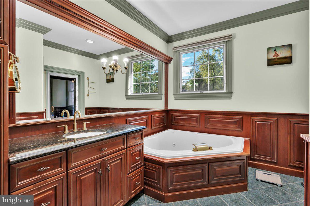 341 Station Avenue Haddonfield, NJ 08033 - Photo 37 of 71 a bathroom with a granite countertop sink and a large mirror