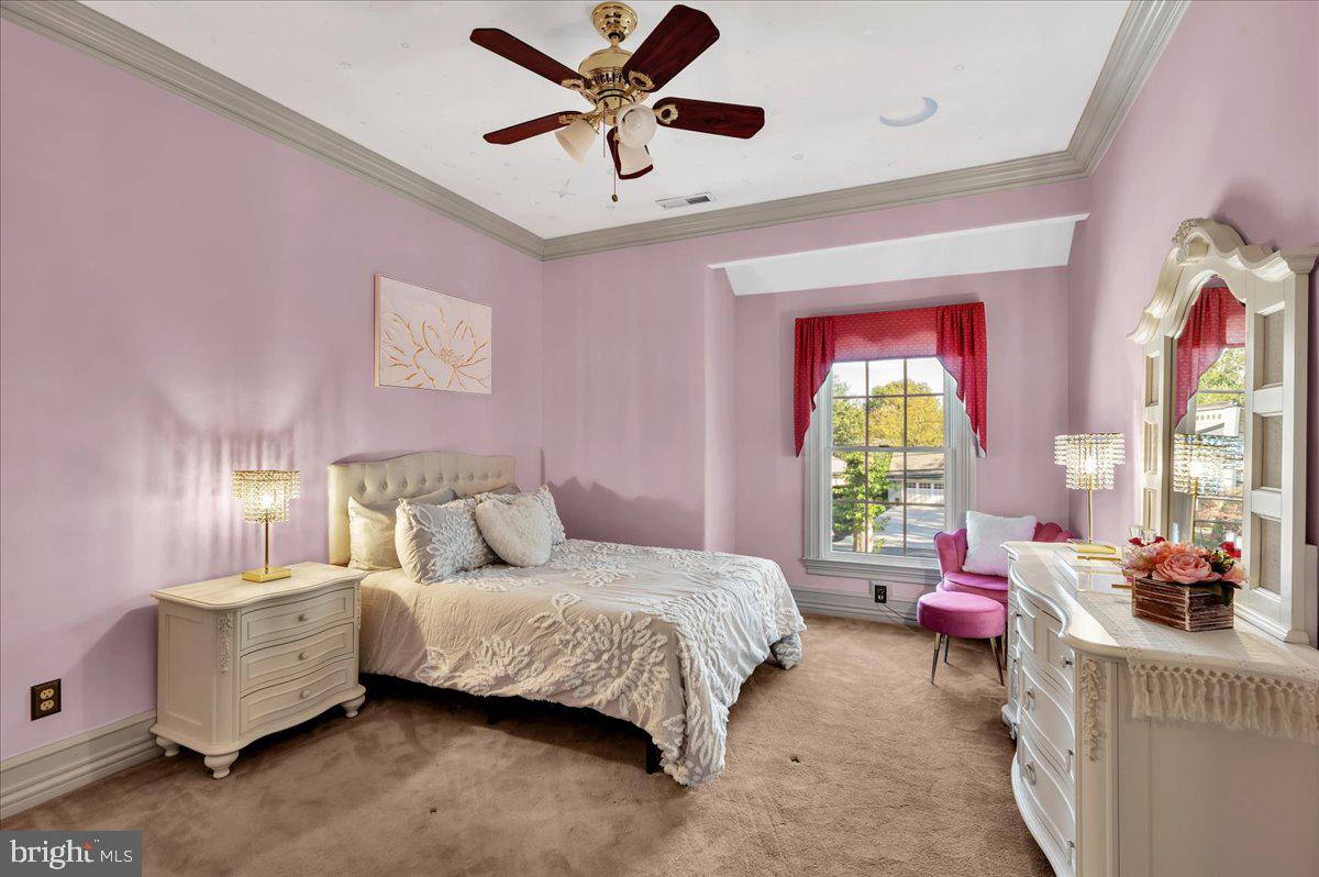 341 Station Avenue Haddonfield, NJ 08033 - Photo 40 of 71 a bedroom with a bed and a chandelier fan