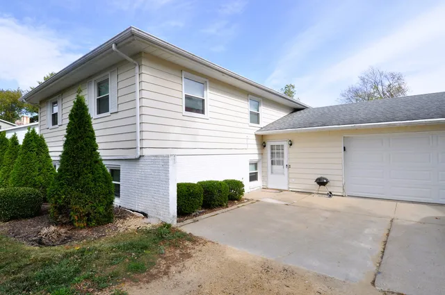 a view of a house with a yard and garage