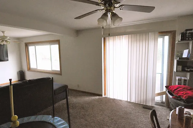 a view of a livingroom with workspace and a window