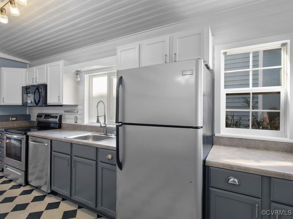 1411 Decatur Street Richmond, VA 23224 - Photo 10 of 20 Kitchen featuring lofted ceiling, sink, gray cabin