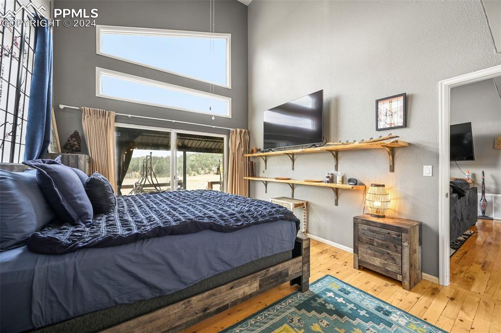 608 Slater Creek Road Guffey, CO 80820 - Photo 16 of 47 a bedroom with a bed and large windows