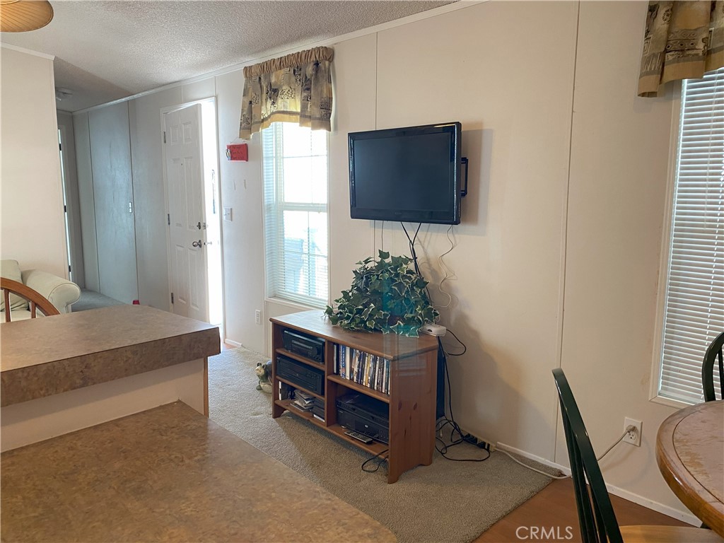 79 6th Needles, CA 92363 - Photo 11 of 15 a living room with furniture and a flat screen tv