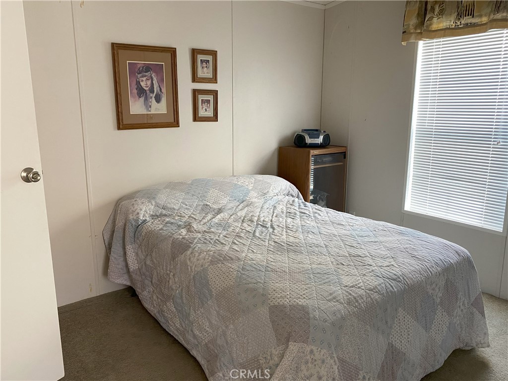 79 6th Needles, CA 92363 - Photo 14 of 15 a bed sitting in a bedroom next to a window