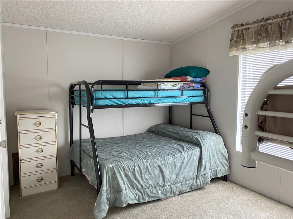 79 6th Needles, CA 92363 - Photo 3 of 15 a bedroom with a bed and a dresser