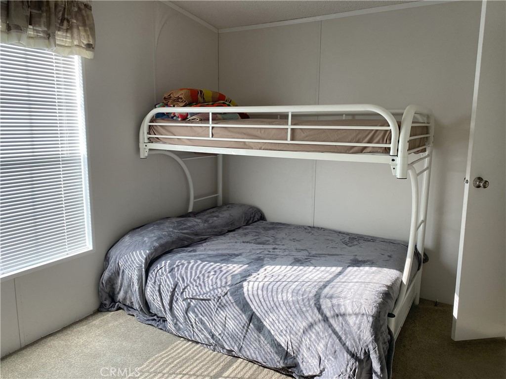 79 6th Needles, CA 92363 - Photo 4 of 15 a bedroom with a bed and window