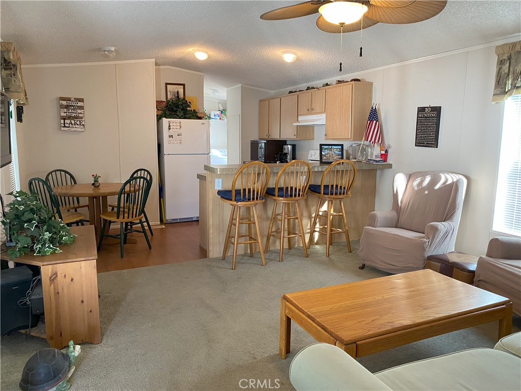 79 6th Needles, CA 92363 - Photo 6 of 15 a living room with furniture a dining table and kitchen view