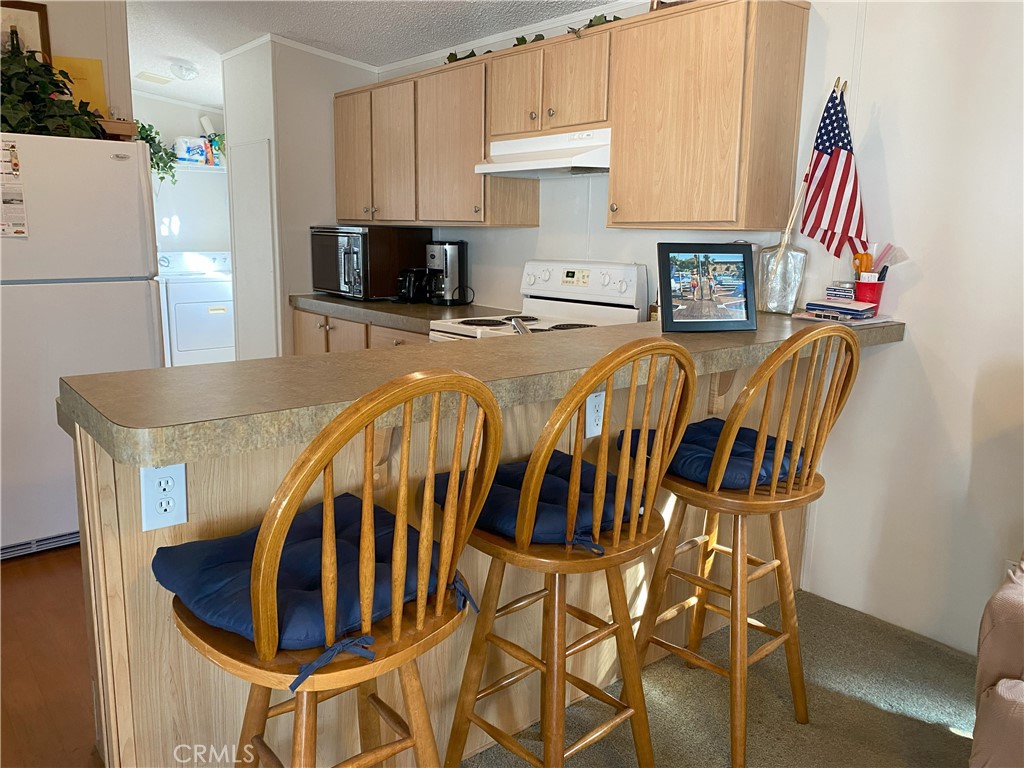79 6th Needles, CA 92363 - Photo 7 of 15 a kitchen with stainless steel appliances a refrigerator a stove a sink and a cabinets