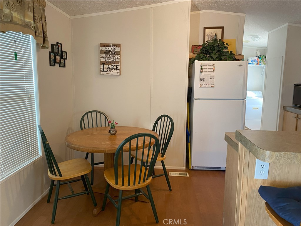 79 6th Needles, CA 92363 - Photo 8 of 15 a view of a dining room with furniture and wooden floor