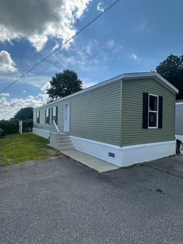 a view of backyard with deck and outdoor seating