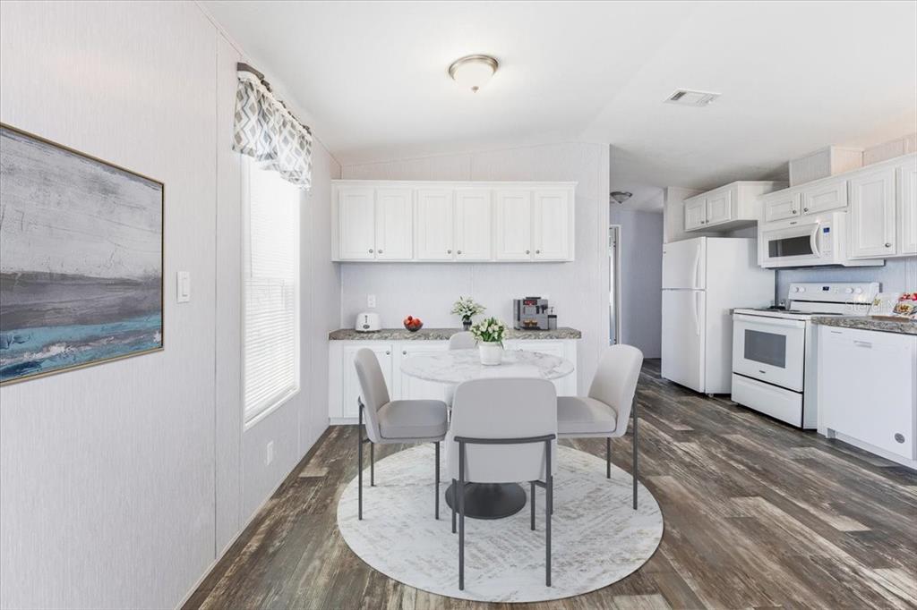 1800 Englewood Road, Unit 166 Englewood, FL 34223 - Photo 11 of 34 a view of kitchen with table and chairs