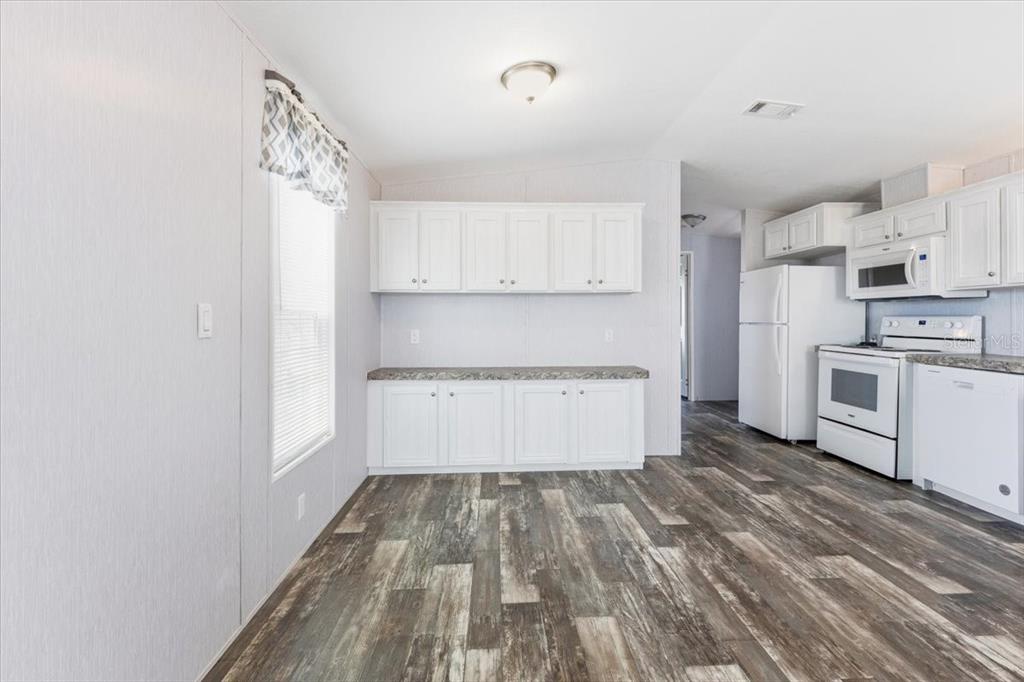 1800 Englewood Road, Unit 166 Englewood, FL 34223 - Photo 12 of 34 a view of a kitchen with wooden floor