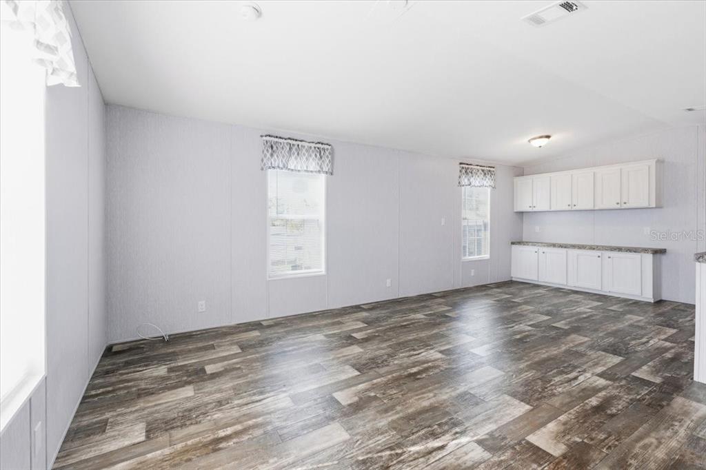 1800 Englewood Road, Unit 166 Englewood, FL 34223 - Photo 13 of 34 a view of a kitchen with a sink and dishwasher a refrigerator with white cabinets