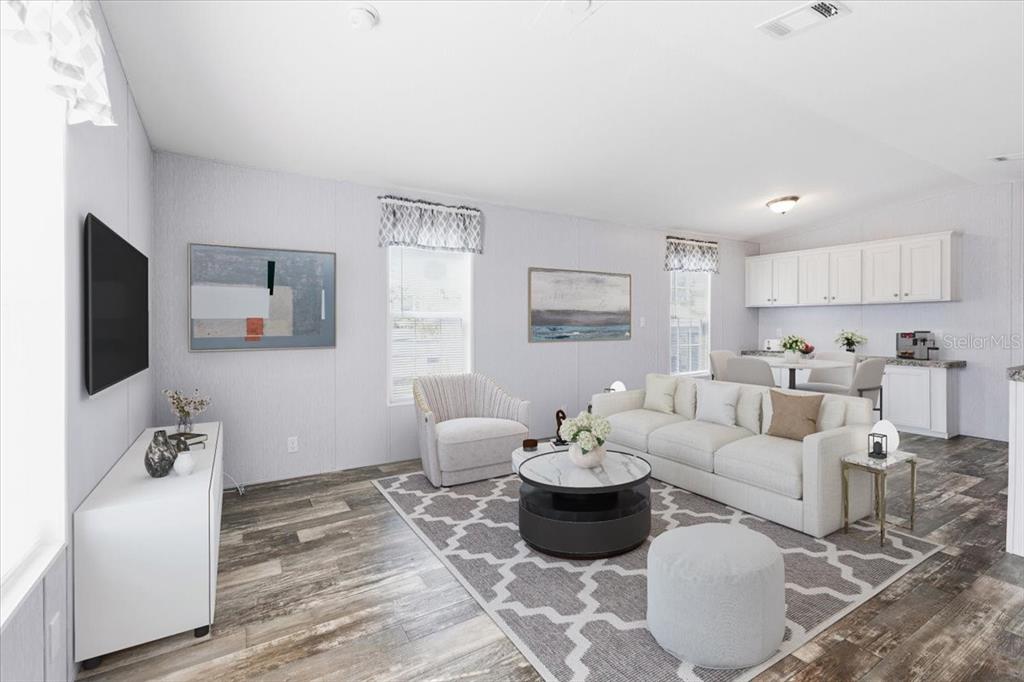 1800 Englewood Road, Unit 166 Englewood, FL 34223 - Photo 14 of 34 a living room with furniture and a flat screen tv