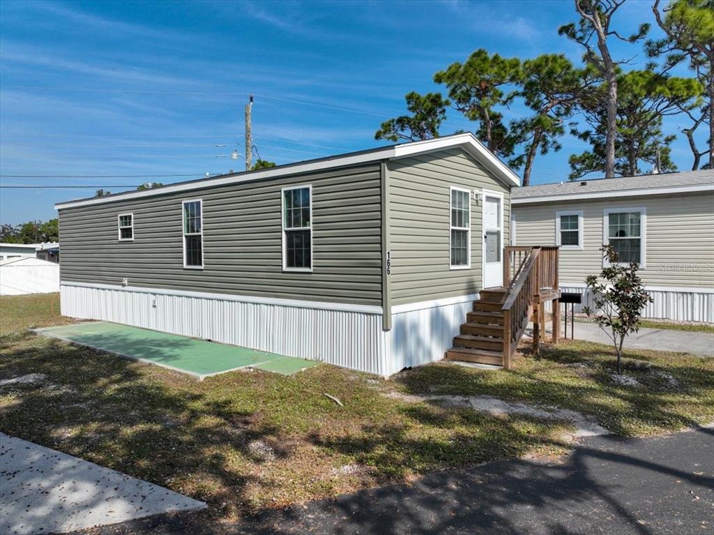 1800 Englewood Road, Unit 166 Englewood, FL 34223 - Photo 29 of 34 a view of a house with a yard