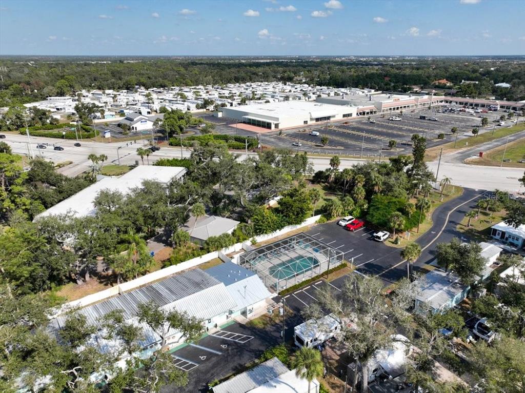 1800 Englewood Road, Unit 166 Englewood, FL 34223 - Photo 32 of 34 a view of a terrace with chairs and a yard