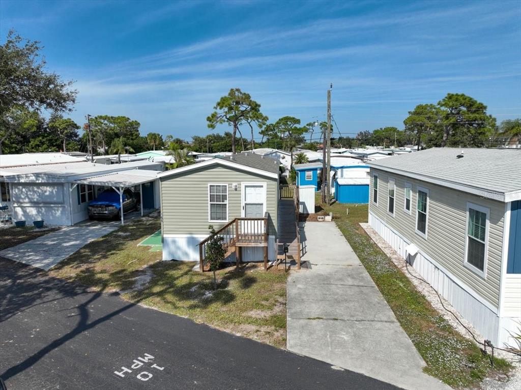 1800 Englewood Road, Unit 166 Englewood, FL 34223 - Photo 4 of 34 a view of a house with a yard