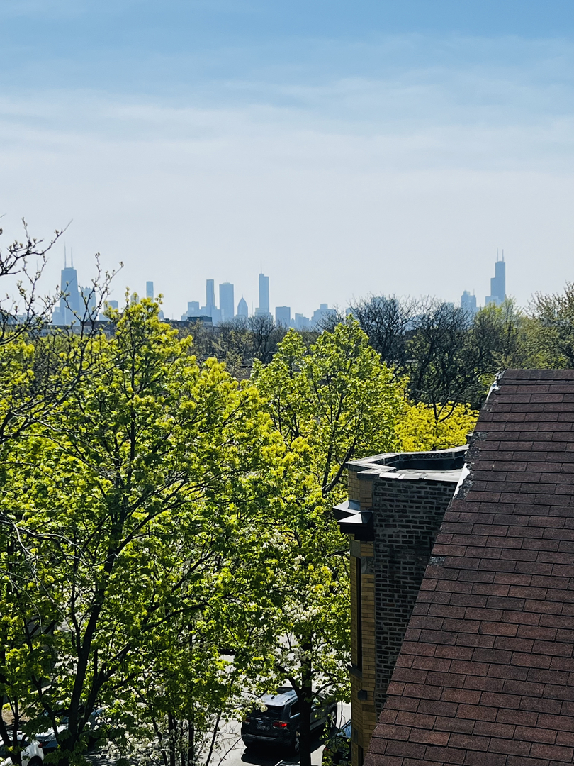 2946 North Racine Avenue, Unit 2 Chicago, IL 60657 - Photo 14 of 17 a view of a balcony with wooden floor and a bench