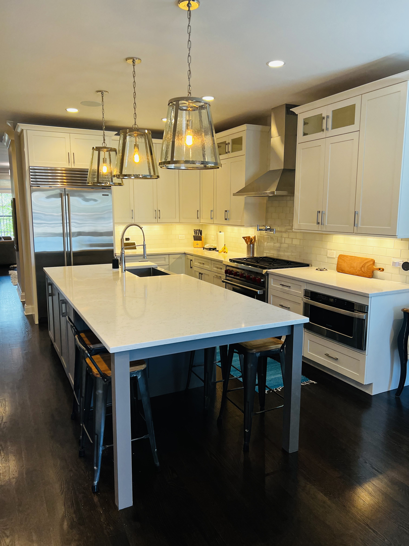 2946 North Racine Avenue, Unit 2 Chicago, IL 60657 - Photo 5 of 17 a kitchen with a sink a stove and chairs