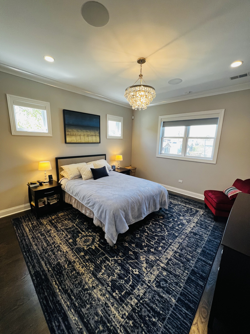 2946 North Racine Avenue, Unit 2 Chicago, IL 60657 - Photo 8 of 17 a bedroom with bed and wooden floor