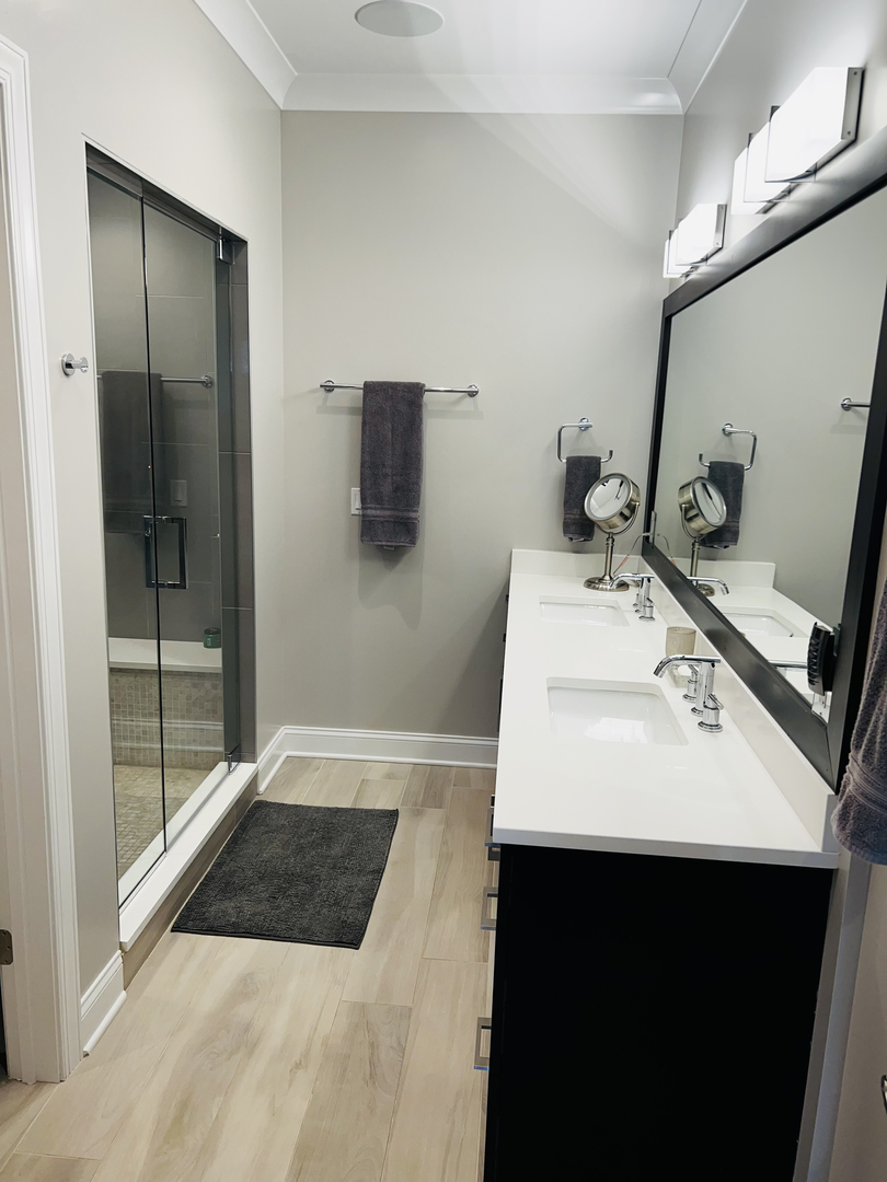 2946 North Racine Avenue, Unit 2 Chicago, IL 60657 - Photo 9 of 17 a bathroom with a sink a toilet and mirror