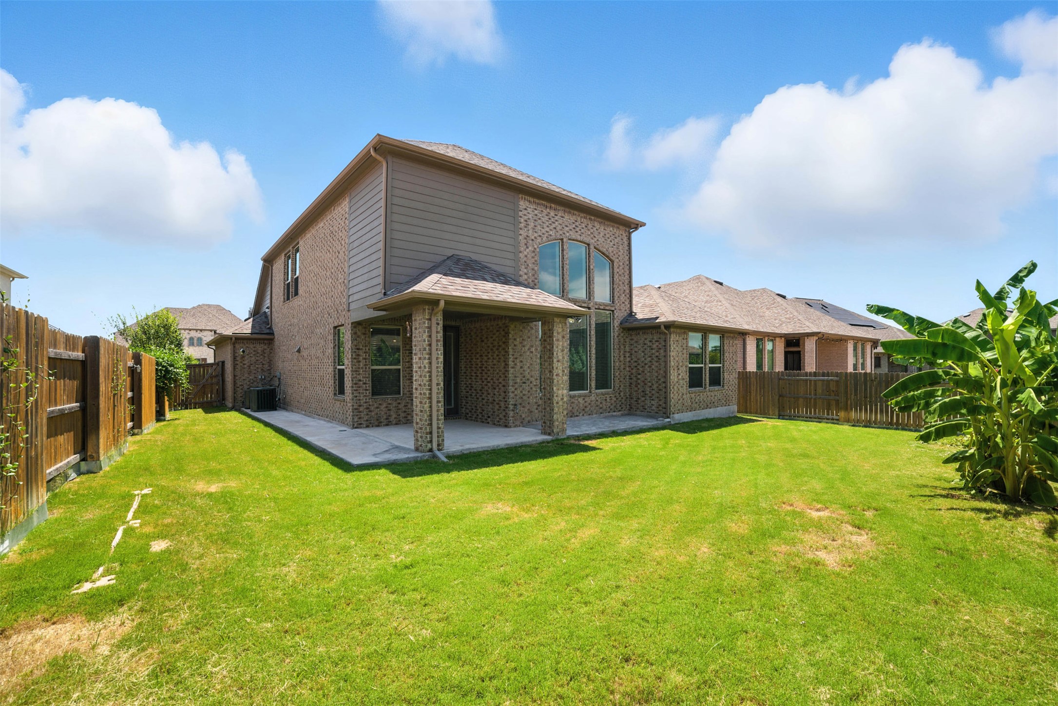 3054 Columbus Loop Round Rock, TX 78665 - Photo 28 of 40 Rear view of house with brick siding, a fenced backyard, and a patio area