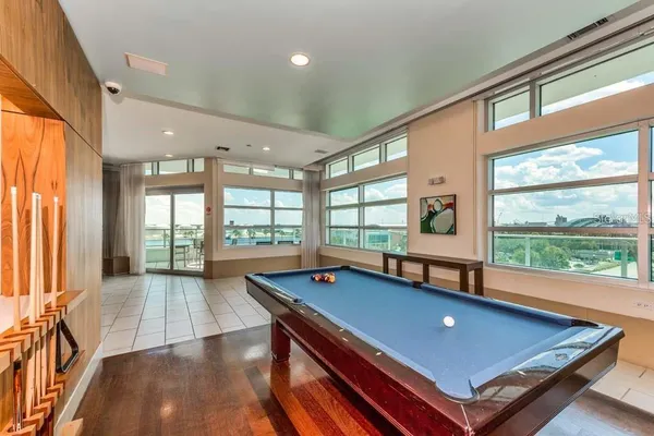 a room with pool table and windows
