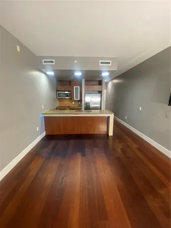 a view of kitchen with cabinets and wooden floor