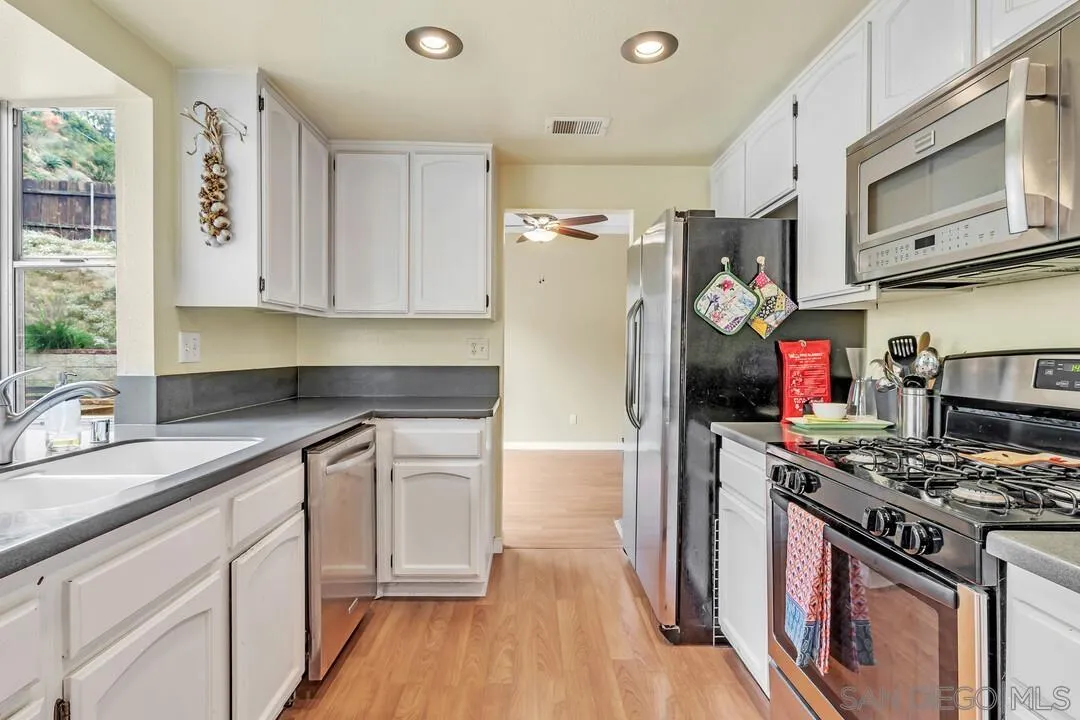 8320 Oconnell Road El Cajon, CA 92021 - Photo 14 of 62 a kitchen with stainless steel appliances granite countertop a stove and a refrigerator