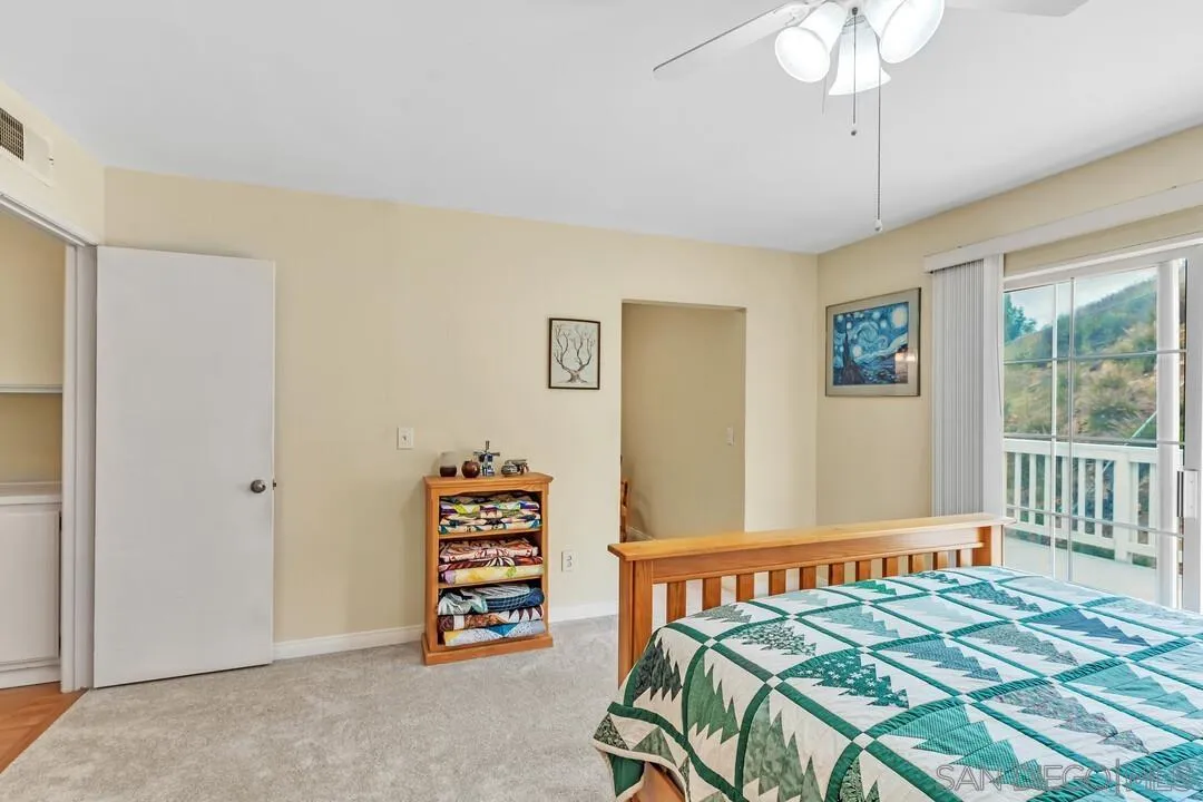 8320 Oconnell Road El Cajon, CA 92021 - Photo 18 of 62 a bedroom with a bed and a chandelier