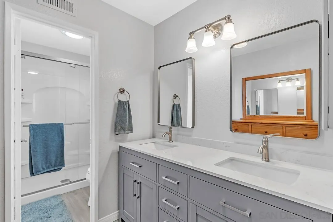 8320 Oconnell Road El Cajon, CA 92021 - Photo 21 of 62 a bathroom with a double vanity sink and a mirror