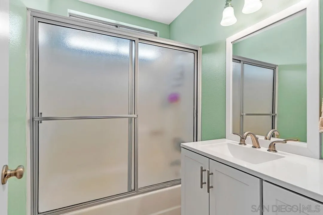 8320 Oconnell Road El Cajon, CA 92021 - Photo 28 of 62 a bathroom with a shower sink and mirror