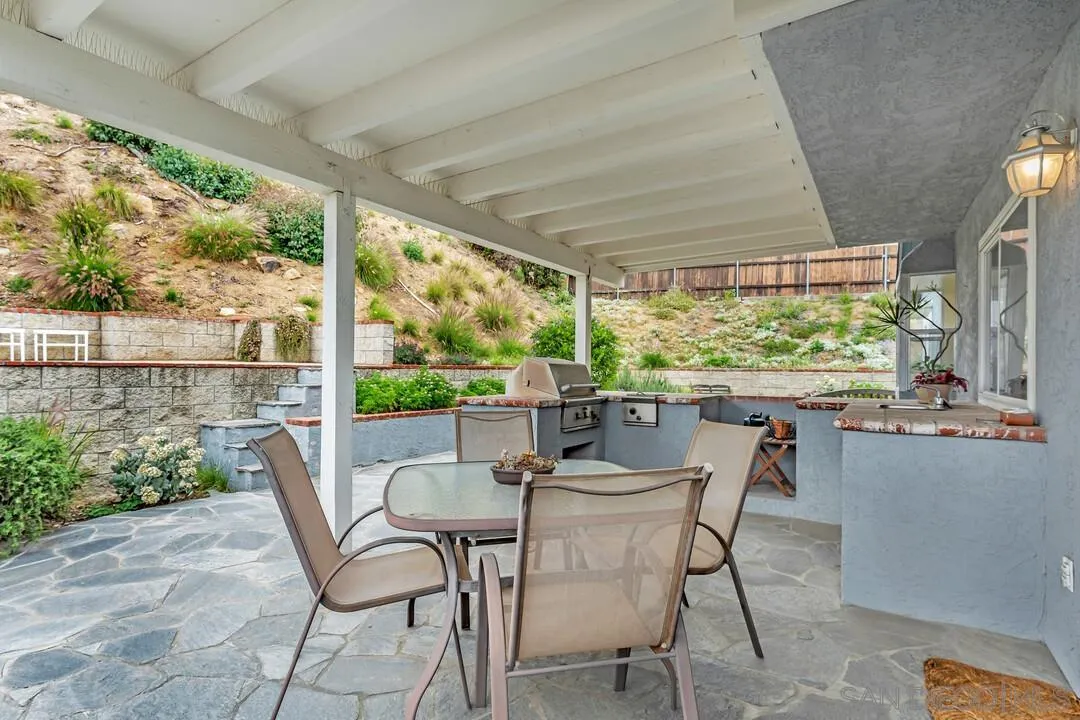 8320 Oconnell Road El Cajon, CA 92021 - Photo 33 of 62 a view of a patio with table and chairs and potted plants
