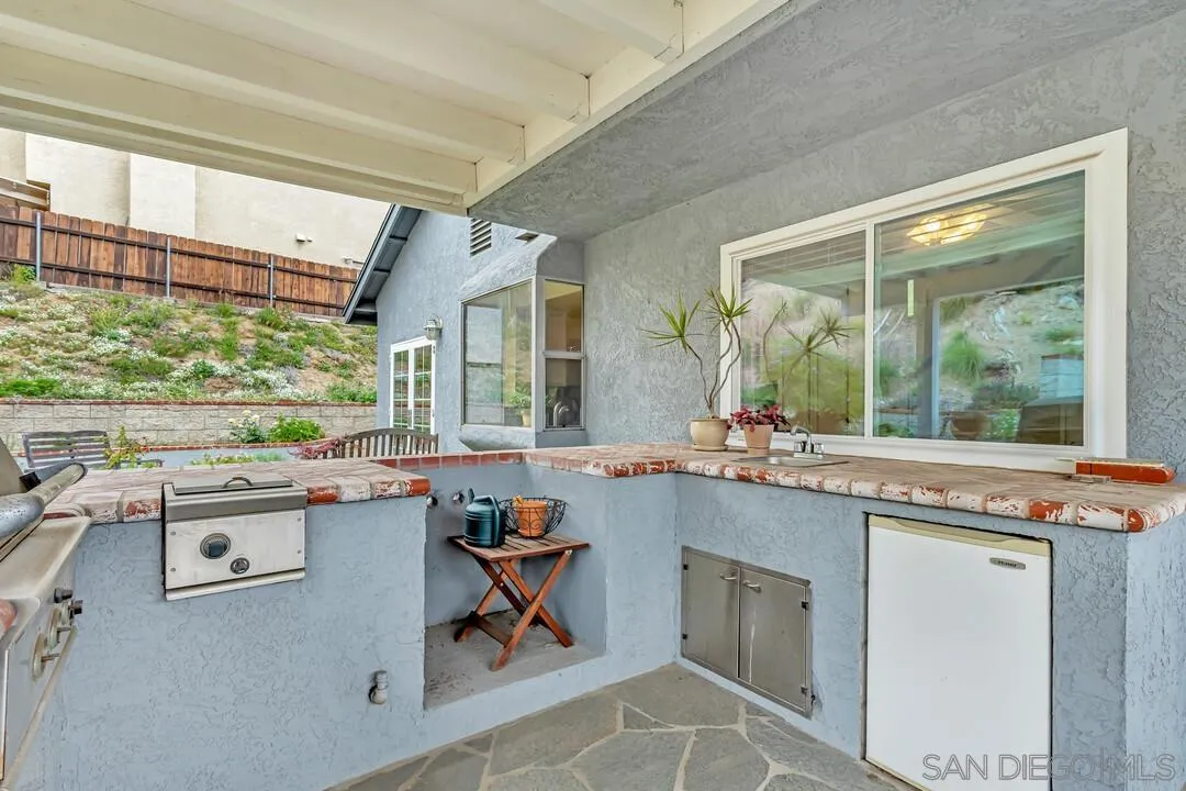 8320 Oconnell Road El Cajon, CA 92021 - Photo 36 of 62 a kitchen with kitchen island a stove a sink and wooden cabinets