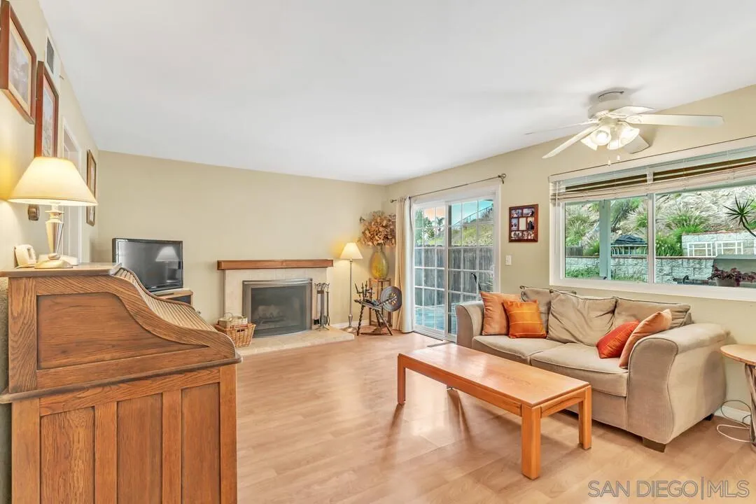 8320 Oconnell Road El Cajon, CA 92021 - Photo 8 of 62 a living room with furniture a fireplace and a large window with balcony view
