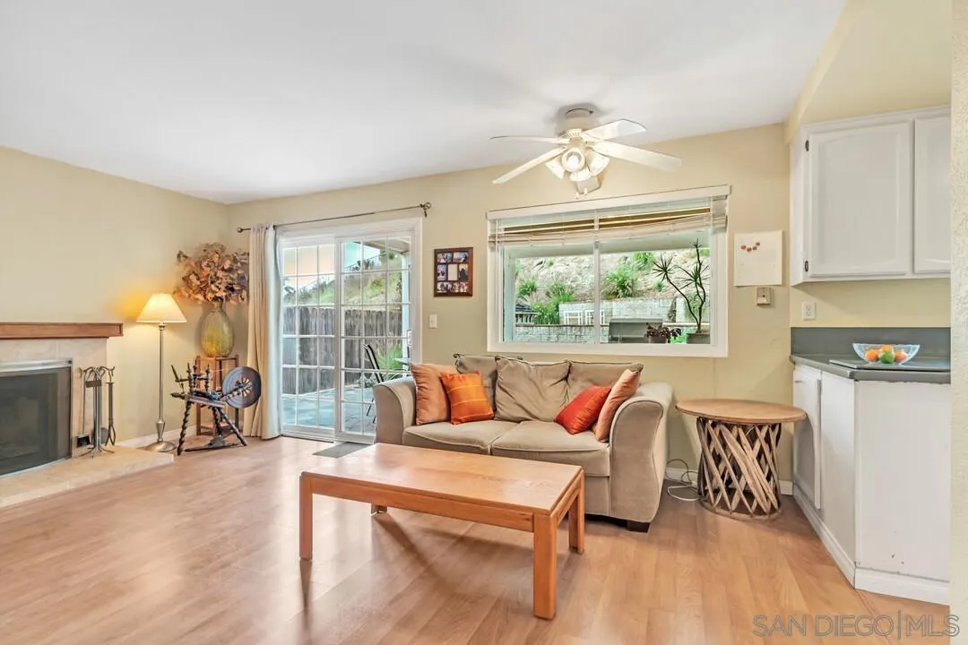 8320 Oconnell Road El Cajon, CA 92021 - Photo 9 of 62 a living room with furniture a fireplace and a chandelier